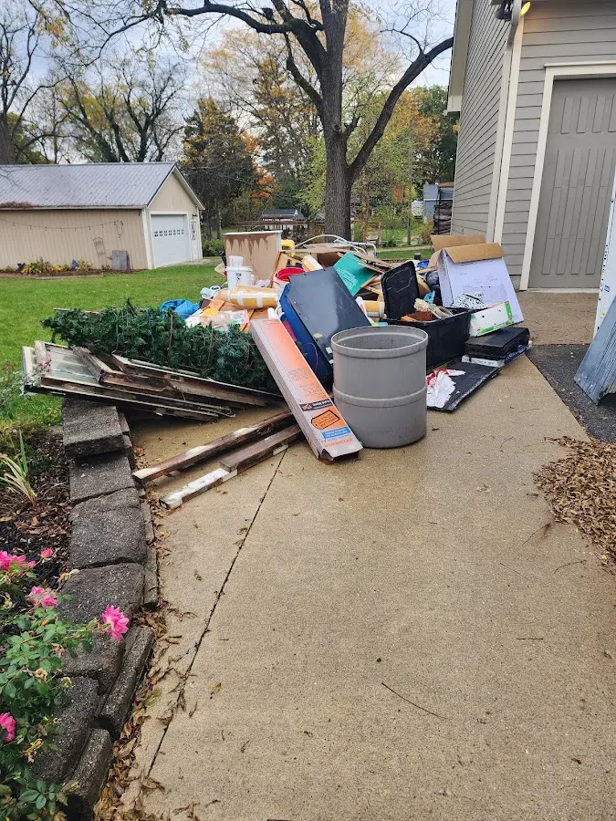 Dumpster being loaded with debris for Estate Cleanout Dumpster Rental in Goulding